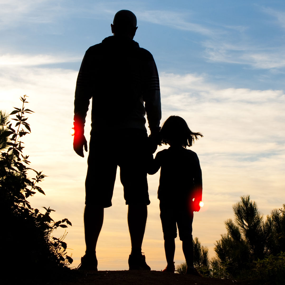 Father and daughter out walking wearing their bright LED Twistii